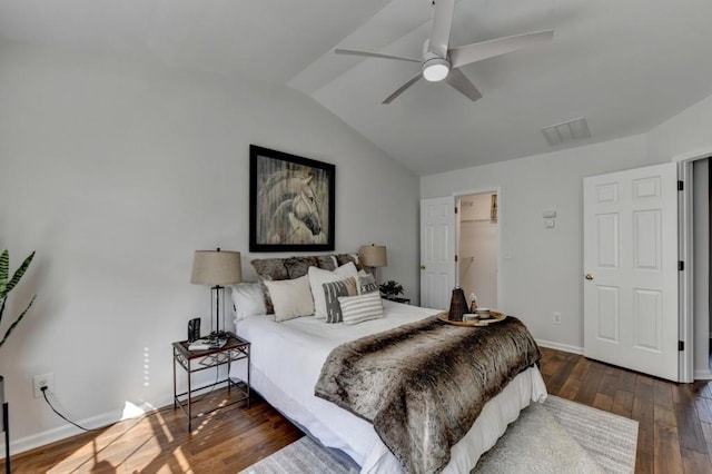 bedroom featuring ceiling fan, a spacious closet, dark hardwood / wood-style floors, a closet, and lofted ceiling