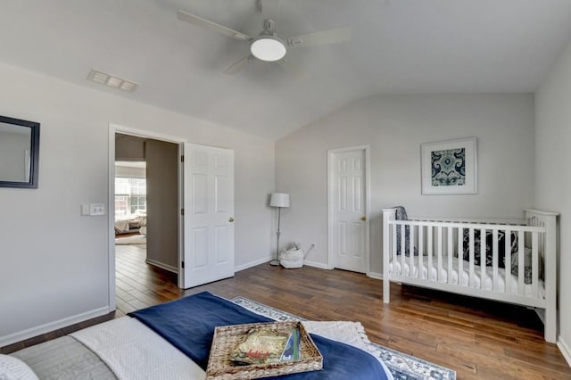 bedroom with hardwood / wood-style floors, ceiling fan, and lofted ceiling