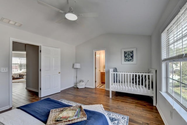 bedroom with multiple windows, dark hardwood / wood-style flooring, and ceiling fan