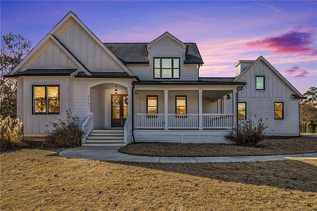 modern inspired farmhouse featuring a porch and a yard