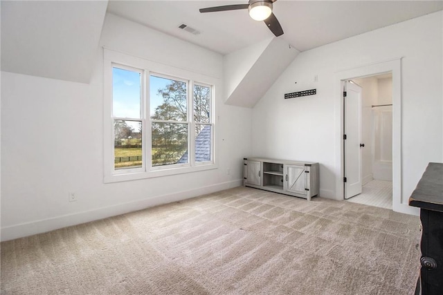 bonus room with ceiling fan and light carpet