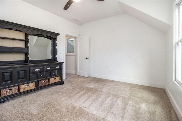 unfurnished bedroom with ceiling fan, light carpet, and lofted ceiling