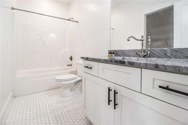 full bathroom with toilet, vanity, tile patterned flooring, and washtub / shower combination