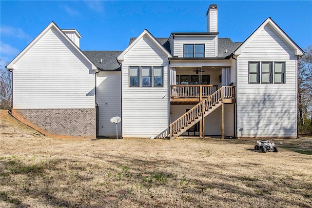 back of property with ceiling fan and a lawn