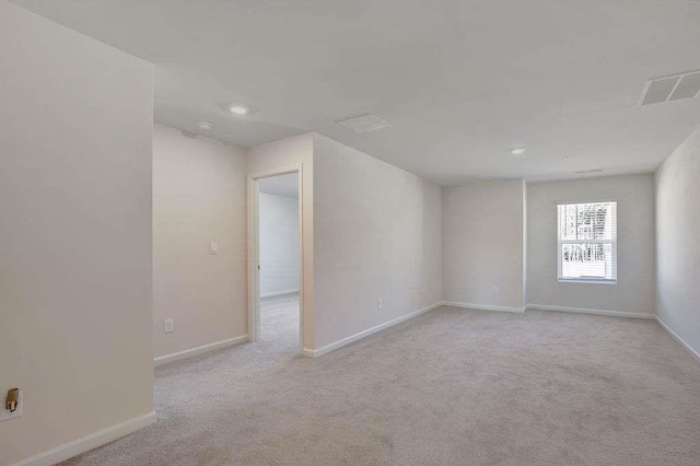 carpeted empty room with visible vents and baseboards