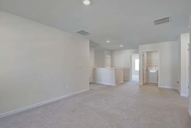 unfurnished living room with light carpet, visible vents, and baseboards