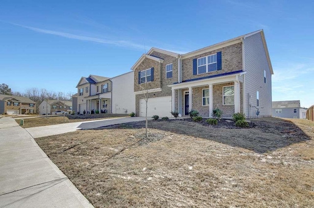 view of front of house featuring a garage, concrete driveway, and a residential view