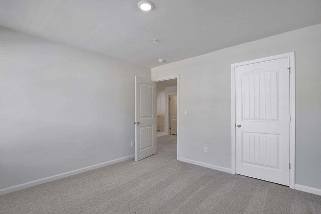 unfurnished bedroom featuring carpet and baseboards