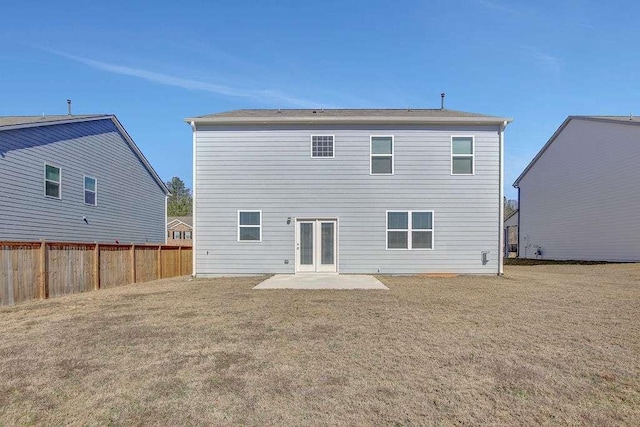 rear view of house with a patio area, fence, and a lawn