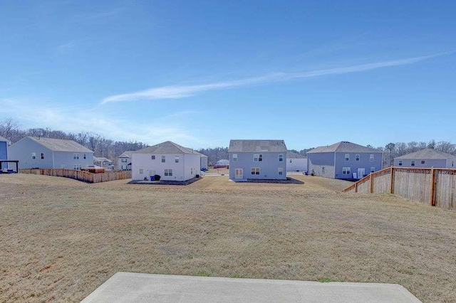 view of yard featuring fence and a residential view