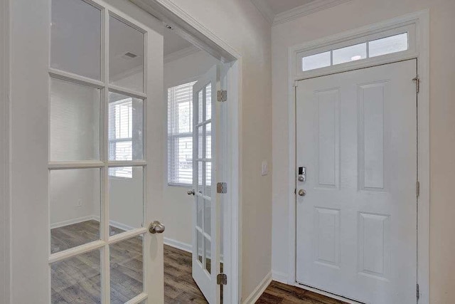 entryway with baseboards, ornamental molding, and wood finished floors