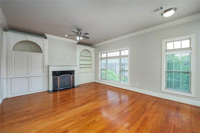 unfurnished living room with ceiling fan, light wood-style flooring, a fireplace with flush hearth, ornamental molding, and baseboards