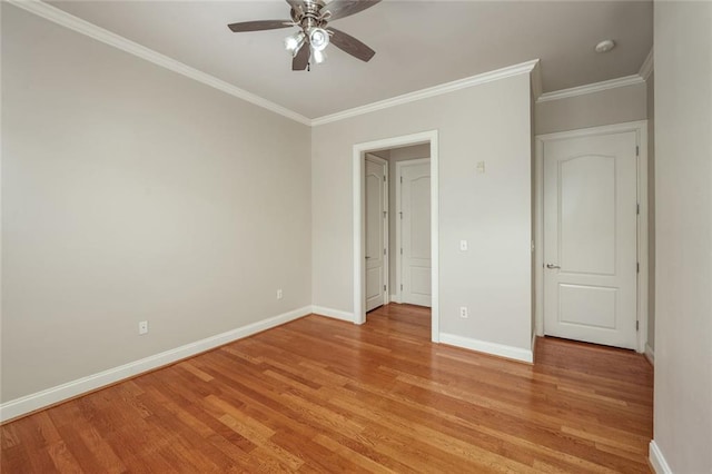 unfurnished bedroom with light wood-style flooring, ornamental molding, baseboards, and ceiling fan
