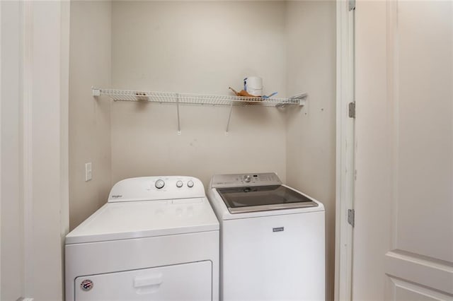 clothes washing area featuring independent washer and dryer