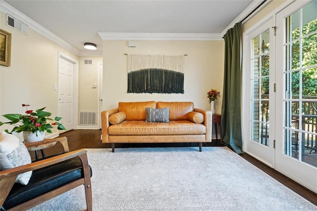 living area with dark hardwood / wood-style flooring and ornamental molding