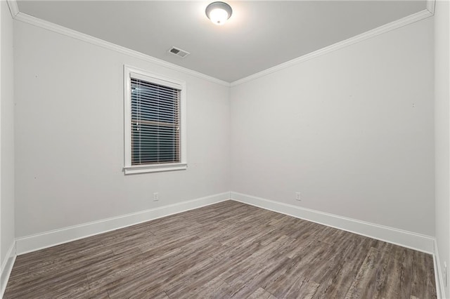 empty room with crown molding and dark hardwood / wood-style floors