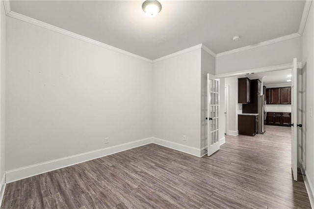 empty room featuring crown molding and hardwood / wood-style floors