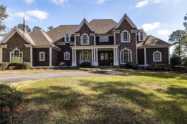 craftsman-style home featuring a front yard