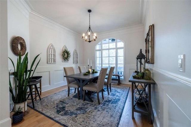 dining space with crown molding, dark hardwood / wood-style flooring, and a notable chandelier