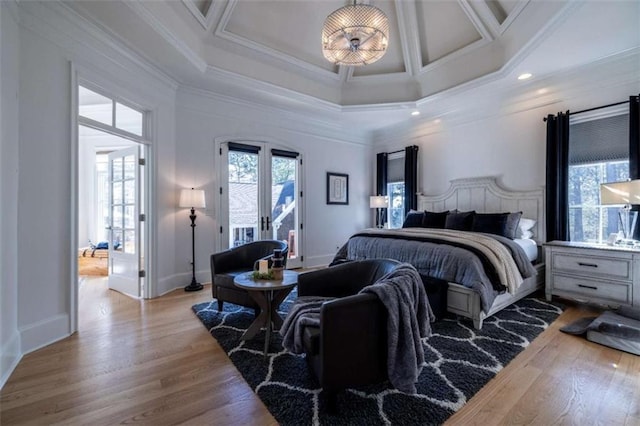 bedroom featuring french doors, coffered ceiling, crown molding, and light hardwood / wood-style floors