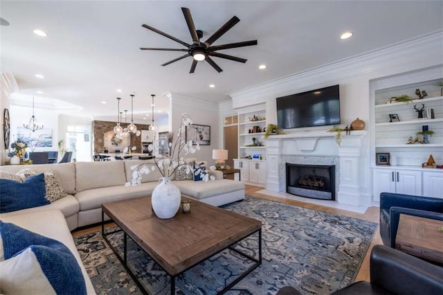2938 Old Dalton Rd, Rome, GA 30165 - living room with ceiling fan with notable chandelier, built in features, a fireplace, ornamental molding, and recessed lighting