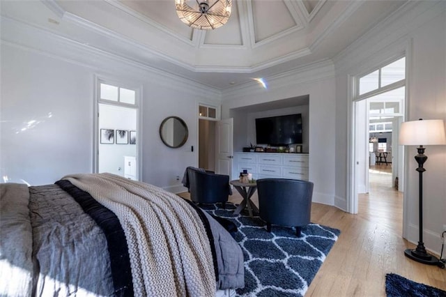 bedroom featuring multiple windows, a towering ceiling, ornamental molding, and light wood-type flooring