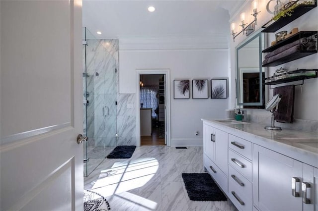 bathroom with vanity, crown molding, and a shower with door