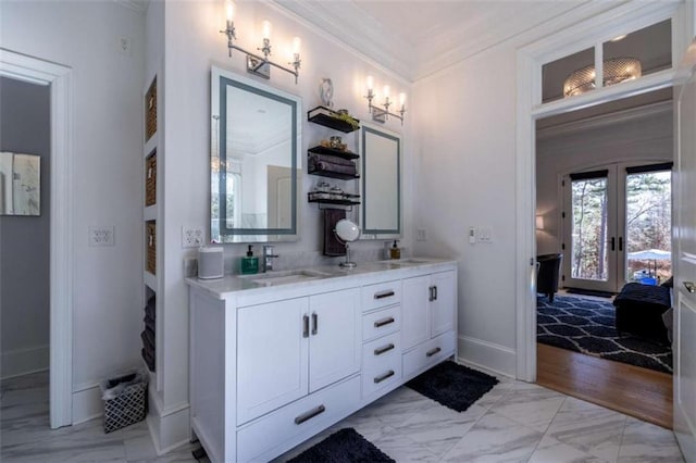 bathroom featuring french doors, ornamental molding, and vanity