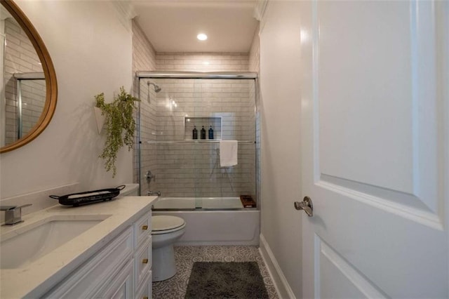 full bathroom featuring vanity, combined bath / shower with glass door, and toilet