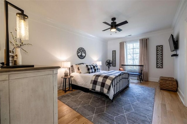 bedroom featuring ceiling fan, ornamental molding, and dark hardwood / wood-style flooring