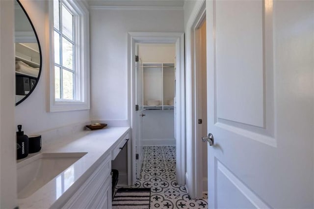 bathroom with vanity and ornamental molding