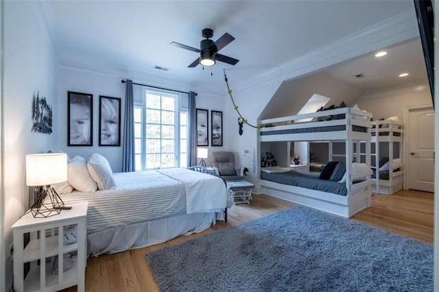 bedroom with crown molding and light hardwood / wood-style floors