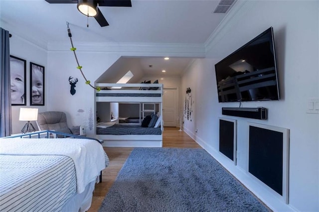 bedroom featuring ornamental molding and hardwood / wood-style floors