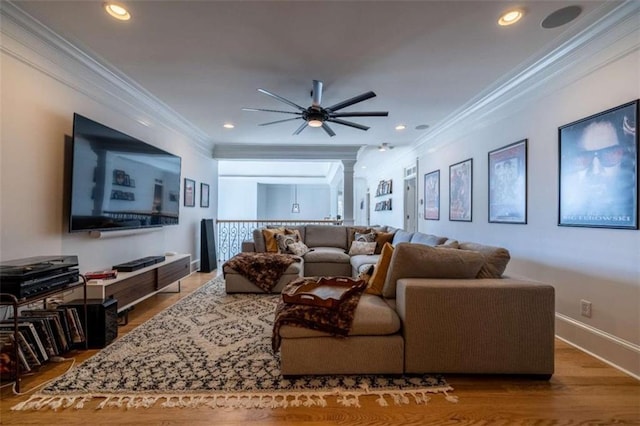 living room featuring crown molding, decorative columns, ceiling fan, and hardwood / wood-style flooring