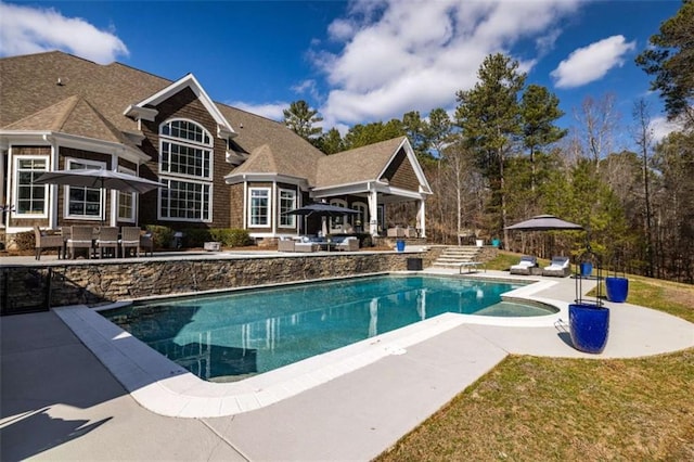 view of swimming pool featuring a lawn and a patio