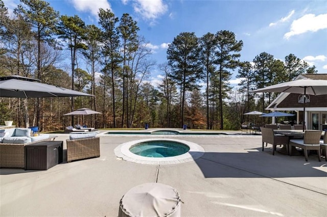 view of pool featuring an outdoor living space, a patio area, and an in ground hot tub