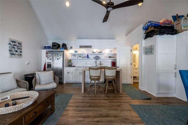 kitchen featuring lofted ceiling, dark hardwood / wood-style floors, stainless steel fridge, and ceiling fan