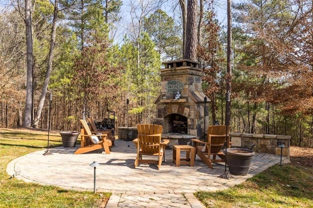 view of patio featuring an outdoor stone fireplace