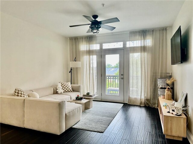 living room with dark hardwood / wood-style floors and ceiling fan