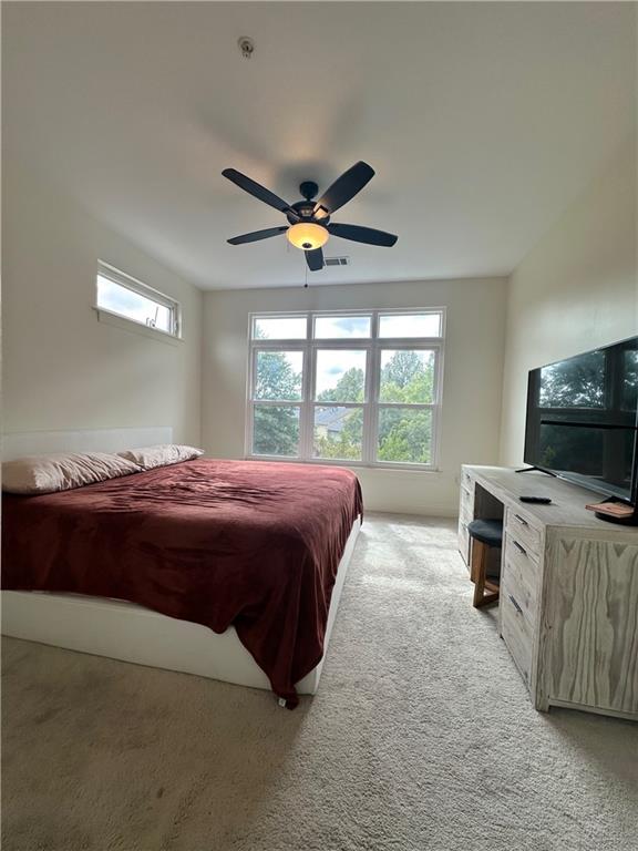 carpeted bedroom featuring ceiling fan