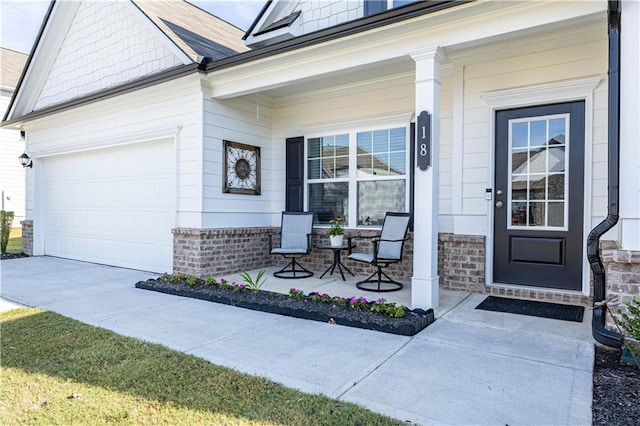 doorway to property featuring covered porch and a garage