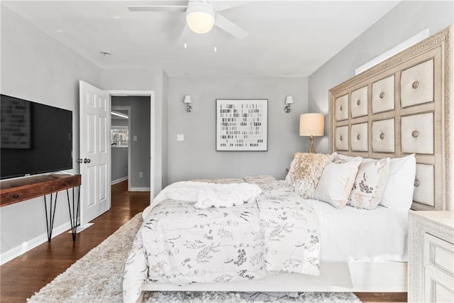 bedroom with ceiling fan, baseboards, and dark wood-style floors