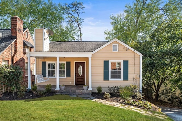 view of front of house with a porch, a front yard, and roof with shingles