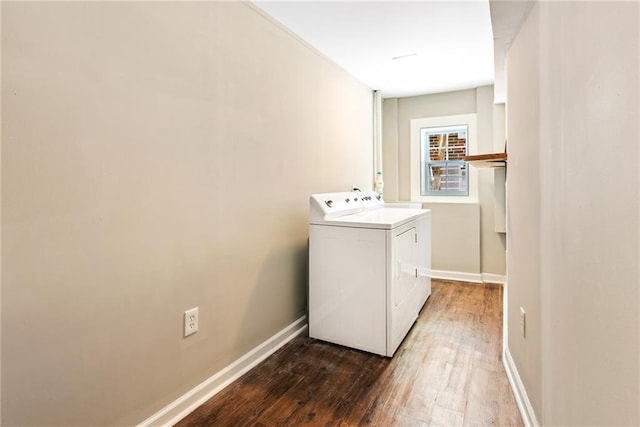 washroom with laundry area, wood finished floors, washing machine and dryer, and baseboards