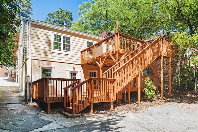 rear view of property with a deck and stairway