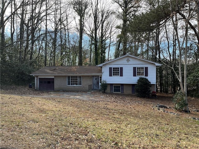 tri-level home featuring a front yard and a garage