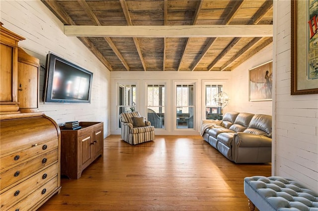 living area featuring wood ceiling, vaulted ceiling with beams, wooden walls, and hardwood / wood-style floors