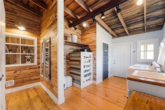 bathroom featuring wood walls, wood ceiling, visible vents, and hardwood / wood-style floors