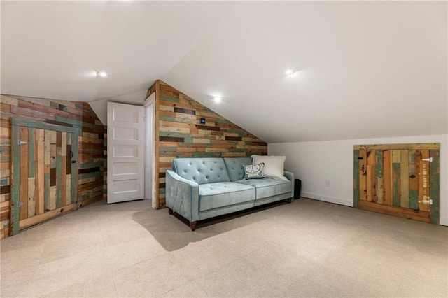 interior space featuring carpet floors and vaulted ceiling