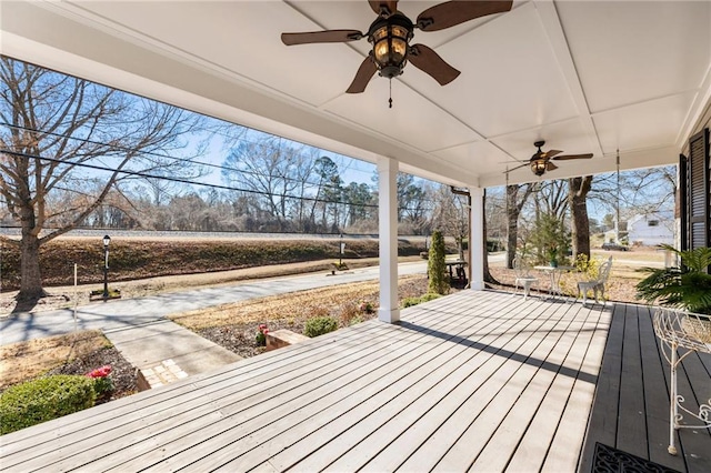 wooden terrace featuring ceiling fan